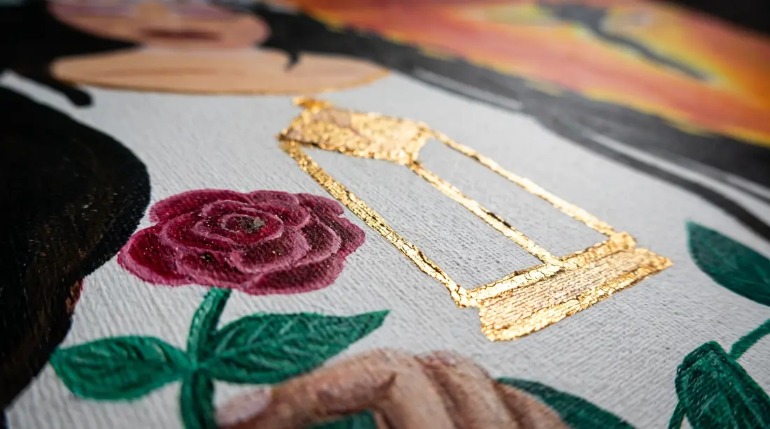 Gold leaf lantern beside a painted rose